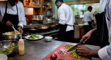Chefs working at distinct kitchen stations