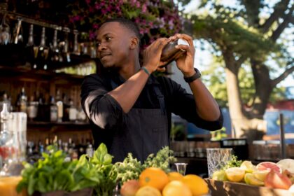 Hands shaking a Boston cocktail shaker