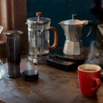 Various home coffee brewing devices on kitchen counter