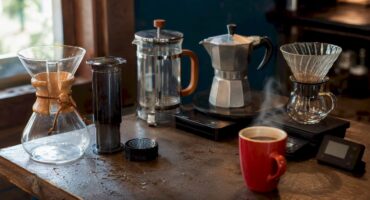 Various home coffee brewing devices on kitchen counter