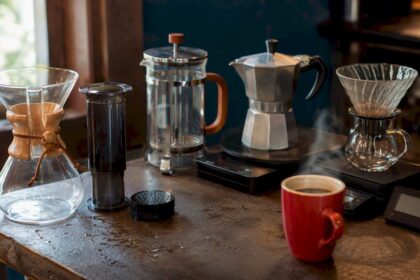 Various home coffee brewing devices on kitchen counter